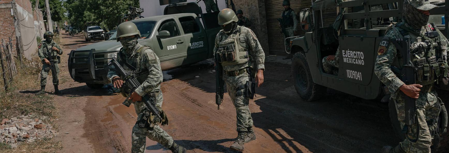 Members of the military arrive at a scene where a key mid-level operator for Ismael "El Mayo" Zambada was captured following a fierce battle between the military and civilians, leaving 19 civilians dead. 