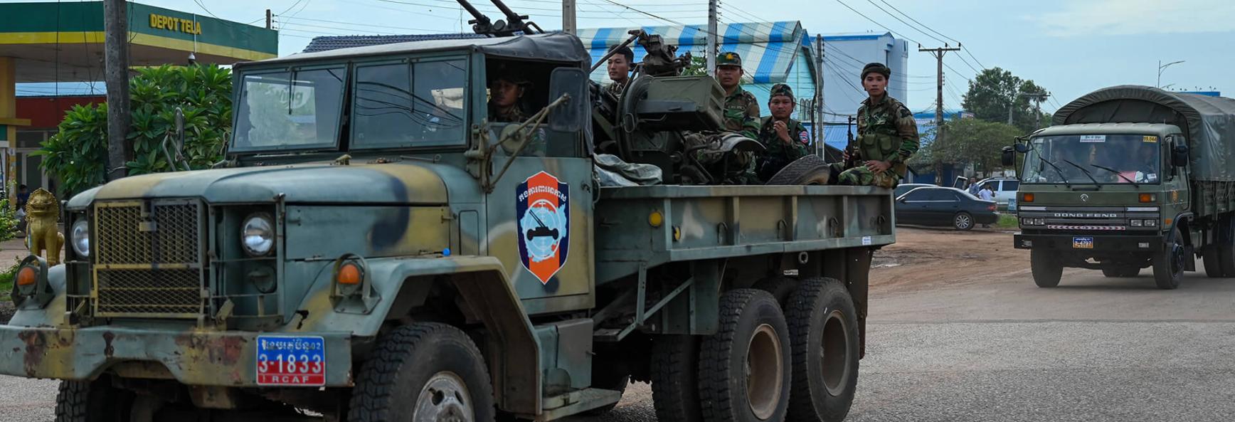 Cambodian soldiers stand on a military truck with an anti-aircraft gun in Oddar Meanchey province on 25 July 2025. 