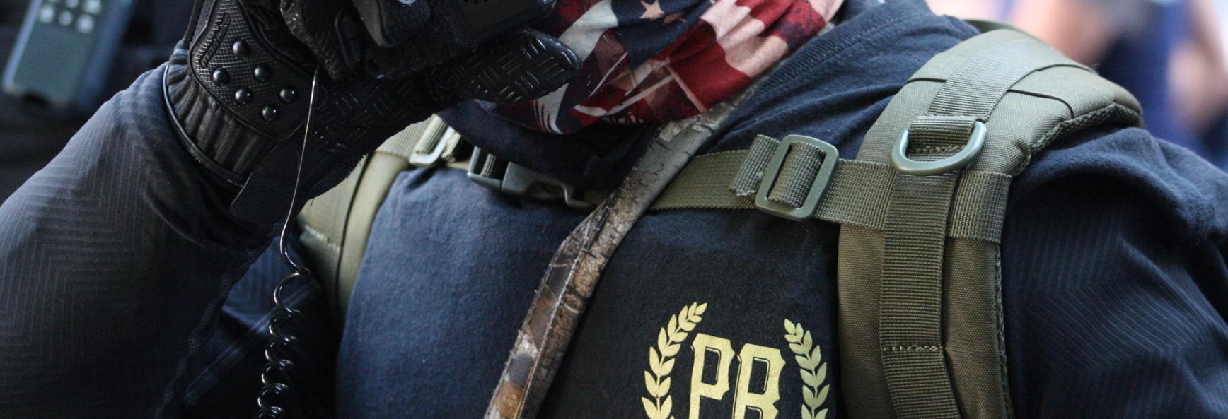 Proud Boys member using a walkie-talkie