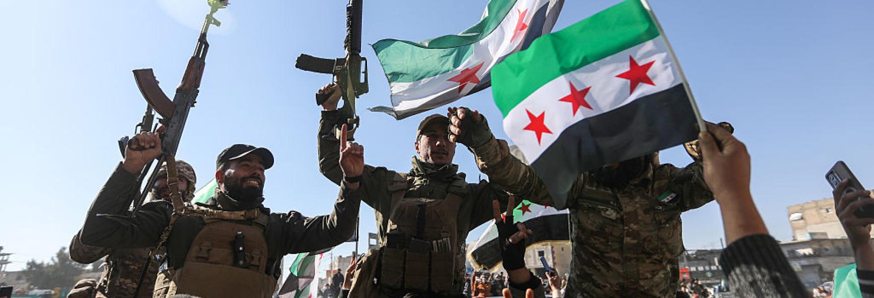 Syrian citizens celebrate and raise Syrian flags on 20 January 2026 in Raqqa