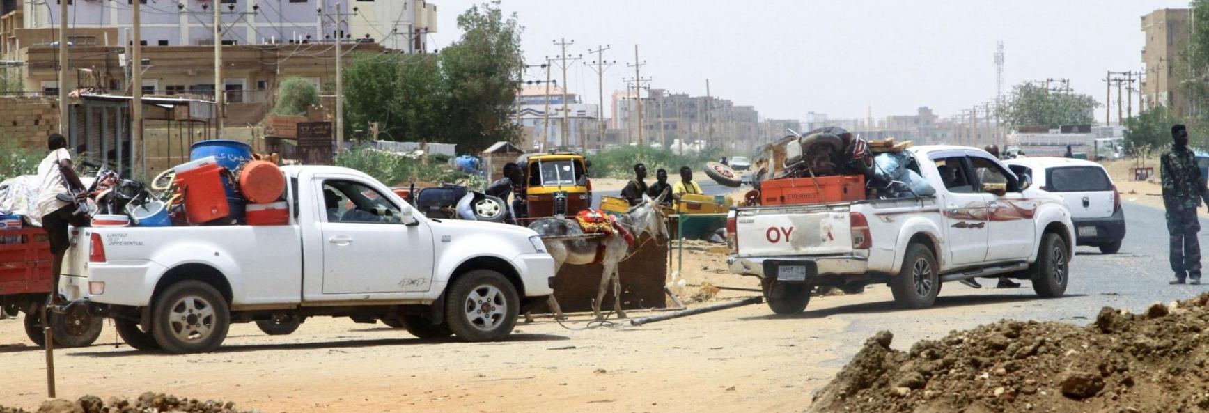 People drive past sand barricades as they return to Omdurman two days after the SAF recaptured it from the RSF on 22 May 2025, securing all of Khartoum state.
