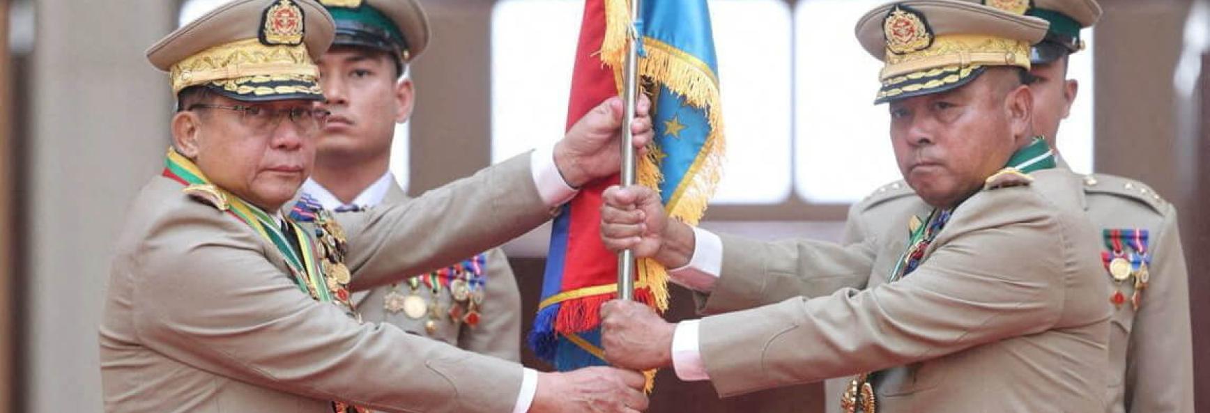 Myanmar junta chief Senior General Min Aung Hlaing hands over a flag to newly appointed Commander-in-Chief General Ye Win Oo during a ceremony in Naypyitaw, Myanmar, 30 March 2026