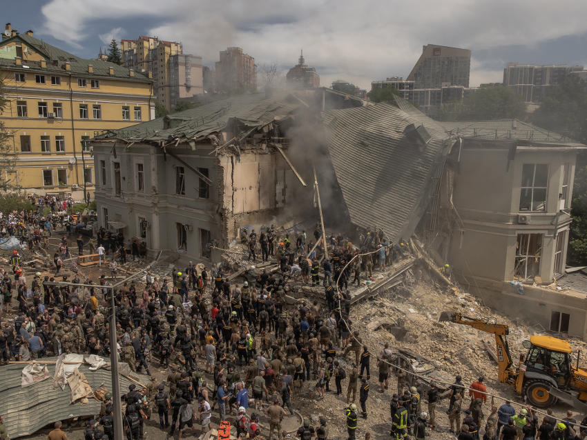 Emergency and rescue personnel along with medics and others clear the rubble of the destroyed building of Ohmatdyt Children’s Hospital following a Russian missile attack (Getty)