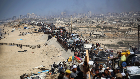  Palestinians from Gaza City move southwards with their belongings, on the coastal road near the Nuseirat refugee camp in the central Gaza Strip, on September 19, 2025. 