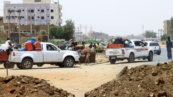 People drive past sand barricades as they return to Omdurman two days after the SAF recaptured it from the RSF on 22 May 2025, securing all of Khartoum state.