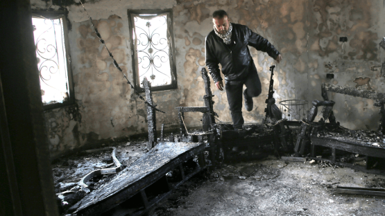 A Palestinian man inspects a burned-out house following an attack by Jewish settlers on 23 March 2026. Photo by Nasser Ishtayeh/SOPA Images/LightRocket via Getty Images