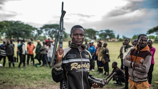 A Wazalendo militant surrenders a weapon to members of the M23 on 15 December 2025 in Uvira.
