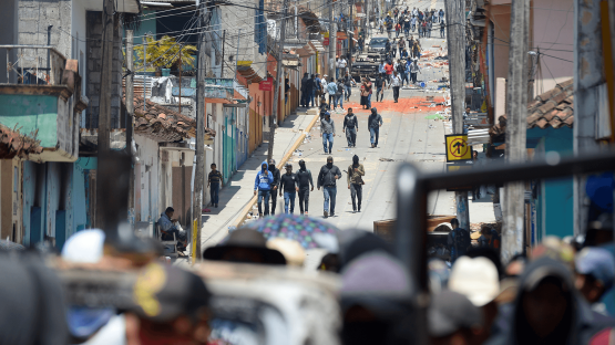 Residents and members of the El Machete self-defense group in Pantelho, Mexico, look for gang members and municipal authorities during a protest against the growing violence in the area.
