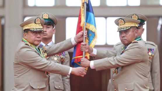 Myanmar junta chief Senior General Min Aung Hlaing hands over a flag to newly appointed Commander-in-Chief General Ye Win Oo during a ceremony in Naypyitaw, Myanmar, 30 March 2026