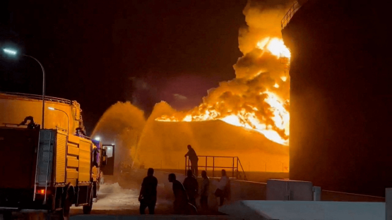 A fire at an oil refinery in Zawiya, Libya, rages as firefighters work to control the blaze on 11 August 2026. 
