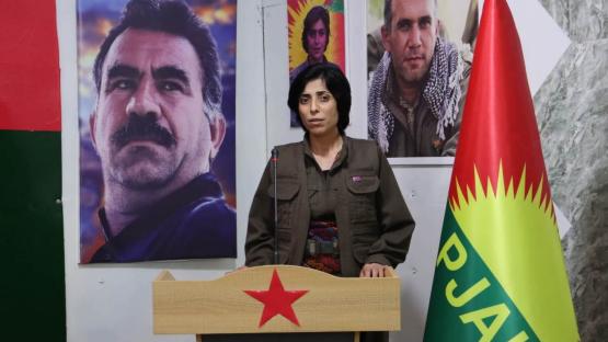 Peyman Viyan, co-chair of the PJAK, at the group&rsquo;s 7th Congress, with a portrait of PKK founder Abdullah &Ouml;calan in the background. 