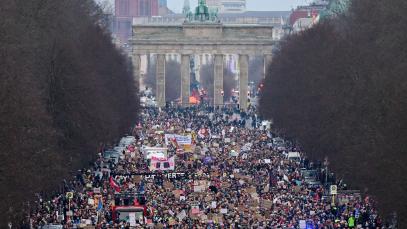 rotesters take part in a demostration under the motto 'Loud against Nazis' with the landmak Brandenburg Gate in the background in Berlin on February 2, 2025. 