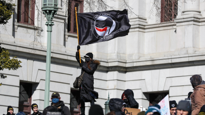 A protester waves an Antifascist Action flag during the "No Kings Day" protest demonstration in Harrisburg, Pennsylvania, Unites States on 17 February 2025. 