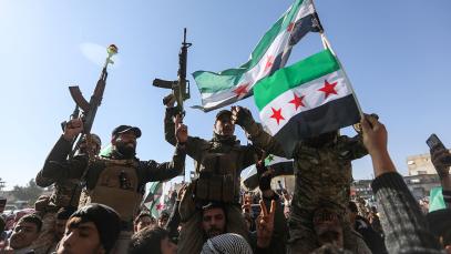 Syrian citizens celebrate and raise Syrian flags on 20 January 2026 in Raqqa