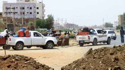 People drive past sand barricades as they return to Omdurman two days after the SAF recaptured it from the RSF on 22 May 2025, securing all of Khartoum state.