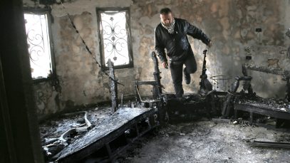 A Palestinian man inspects a burned-out house following an attack by Jewish settlers on 23 March 2026. Photo by Nasser Ishtayeh/SOPA Images/LightRocket via Getty Images