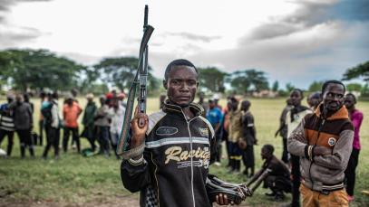 A Wazalendo militant surrenders a weapon to members of the M23 on 15 December 2025 in Uvira.
