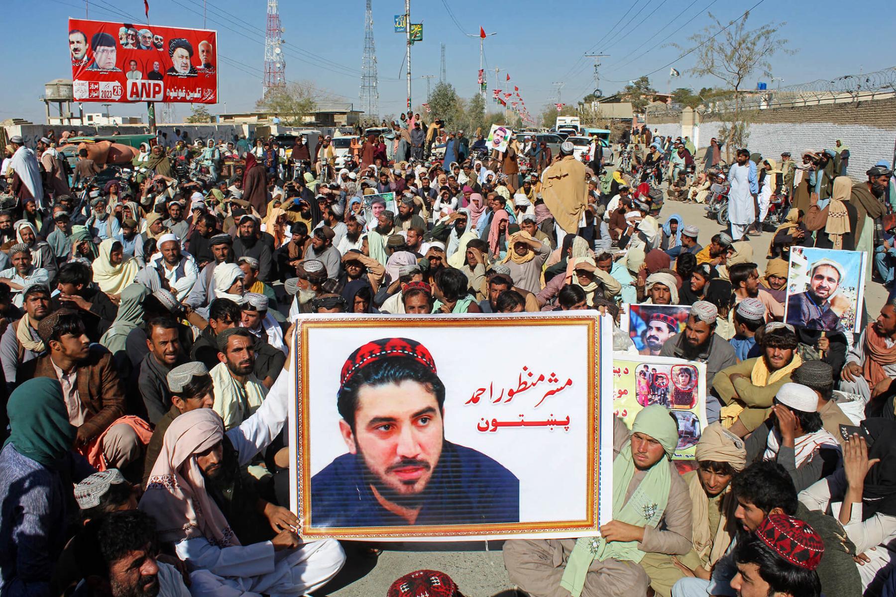 Supporters carry a poster of Manzoor Pashteen, the chief of the Pashtun Tahaffuz Movement, during a demonstration to condemn his detention by police in Chaman on 5 December 2023