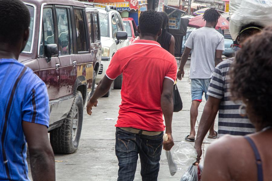 People receive machetes from community leader Nertil Marcelin as part of an initiative to resist gangs in the Delmas district of Port-au-Prince on 16 May 2023.