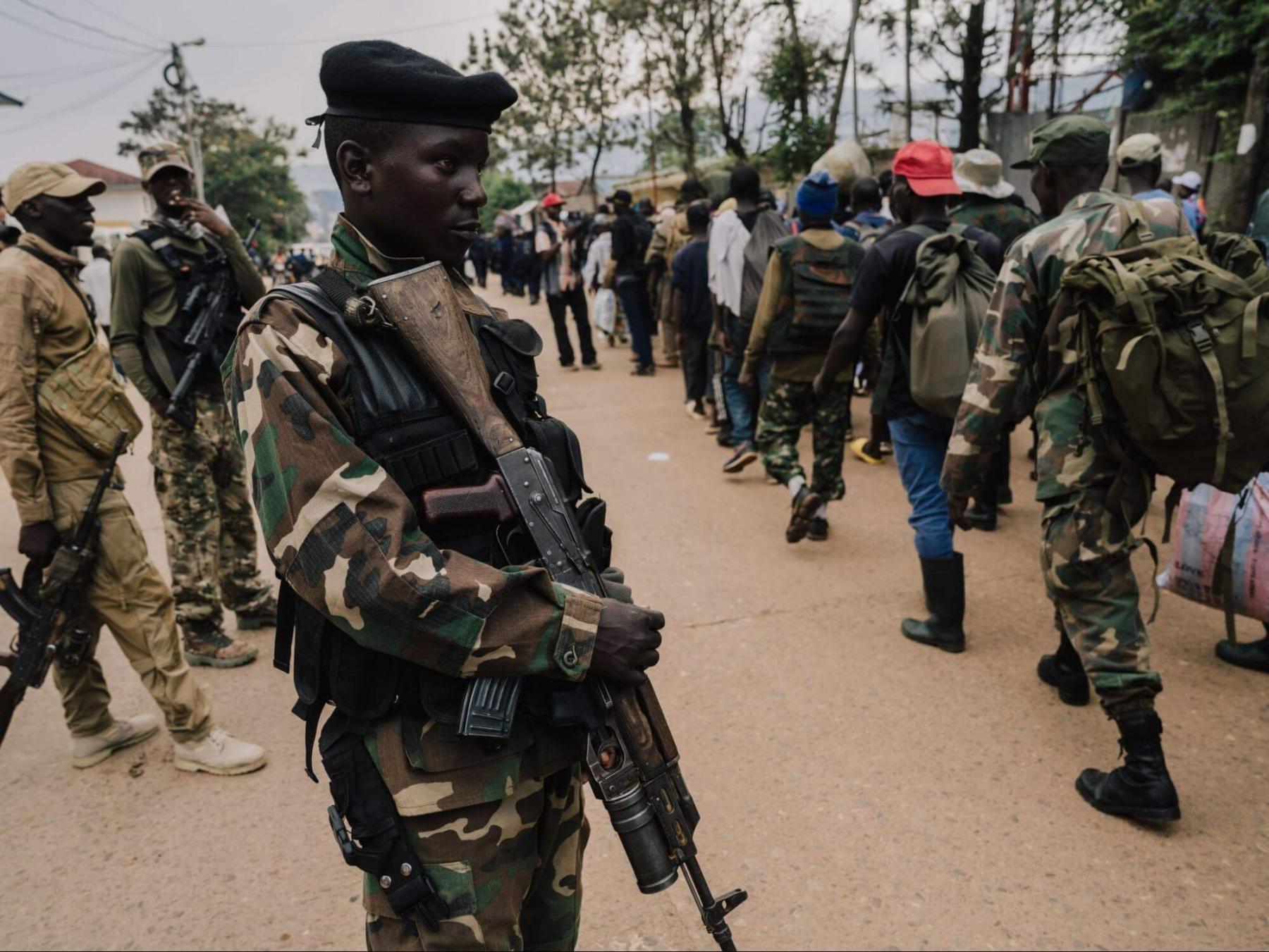M23 rebels are pictured on 22 February 2025 in Bukavu as they guard a unit of surrendering Congolese military troops